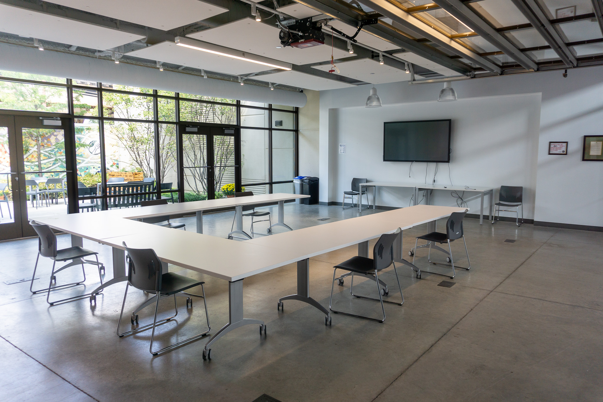 Large meeting room with conference table and access to outdoor patio.